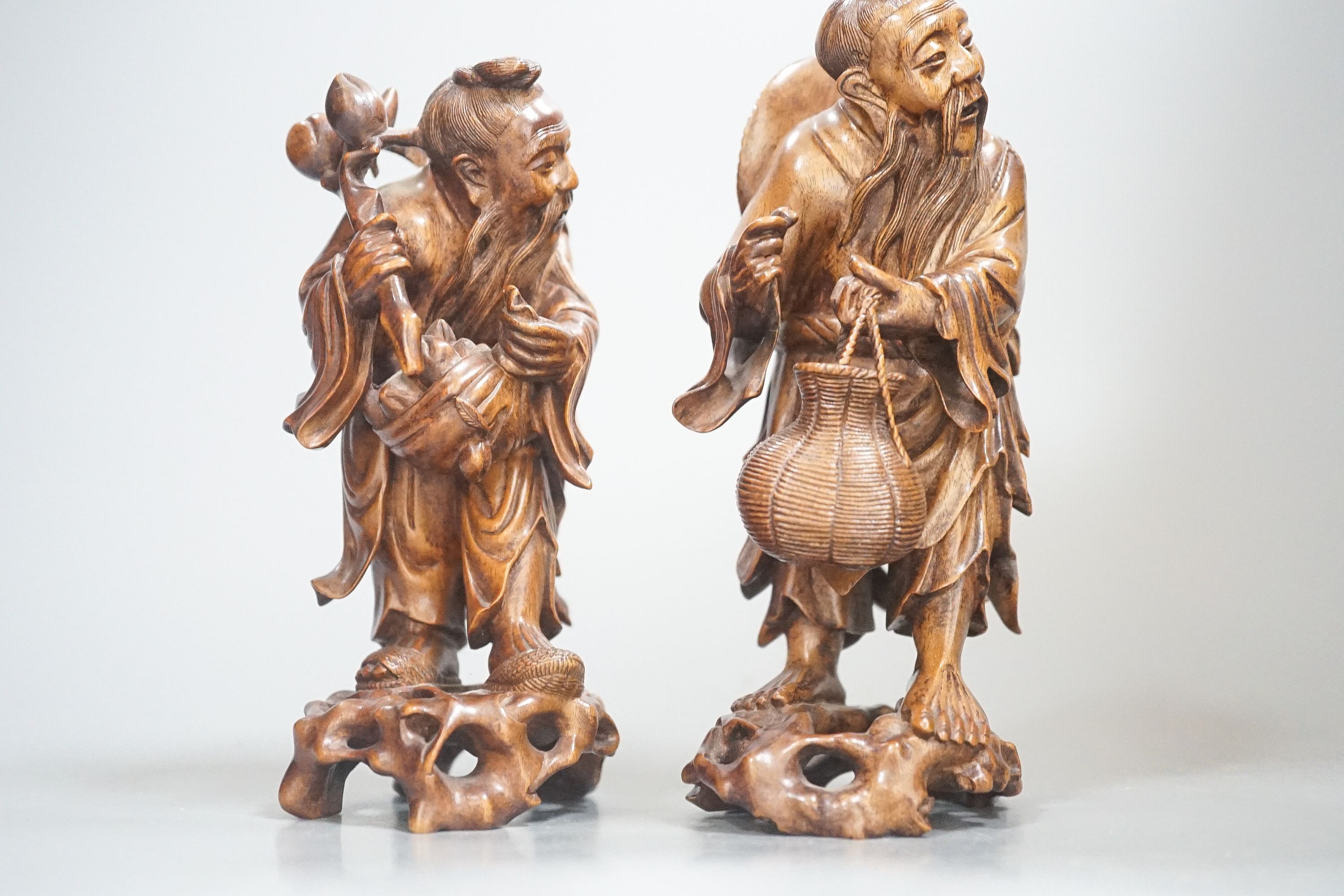 Two Chinese hardwood figures of a fisherman and a old man holding peaches 16cm